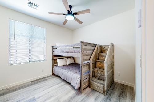 a bedroom with a bunk bed and a ceiling fan at Desert Oasis in Prescott Valley