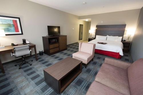 a hotel room with a bed and a desk at Hampton Inn & Suites Oklahoma City Airport in Oklahoma City
