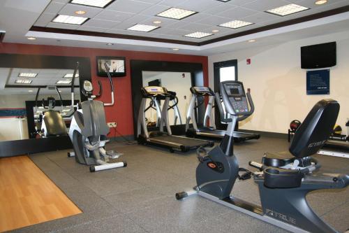 a gym with several cardio machines in a room at Hampton Inn Olive Branch in Olive Branch