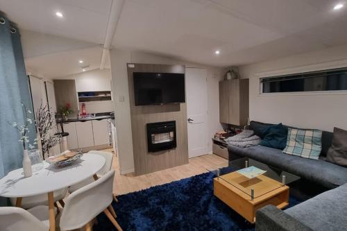 a living room with a couch and a table at The Summer House in Heysham