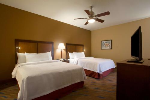 a hotel room with two beds and a flat screen tv at Homewood Suites by Hilton Oklahoma City-Bricktown in Oklahoma City