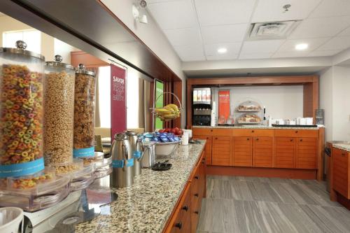 a kitchen with a counter with many different types of food at Hampton Inn & Suites by Hilton Barrie in Barrie