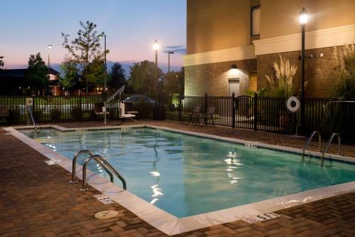 a swimming pool at night in a hotel at Hampton Inn Oxford/Conference Center in Oxford