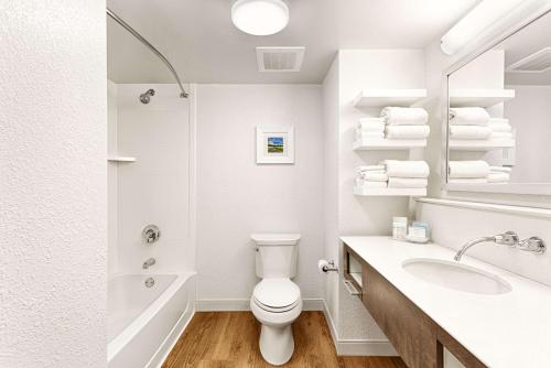 a white bathroom with a toilet and a sink at Hampton Inn Pawleys Island in Pawleys Island