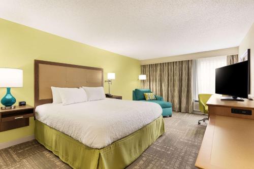 a hotel room with a bed and a television at Hampton Inn Pawleys Island in Pawleys Island