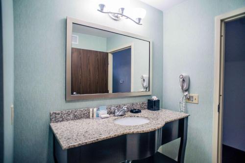 a bathroom with a sink and a mirror at Hampton Inn - Monticello in Monticello