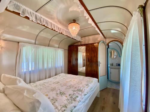 a bedroom with a bed in a train car at Azienda agricola Della Mezzaluna in Stiava