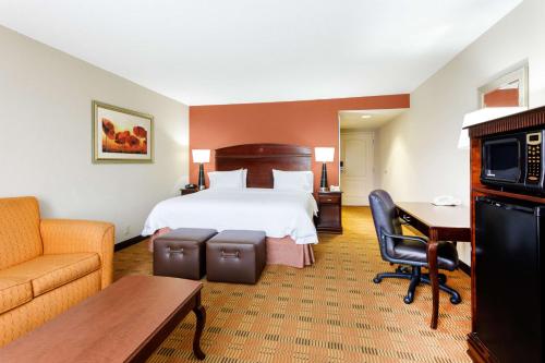 a hotel room with a bed and a desk at Hampton Inn Moss Point in Moss Point