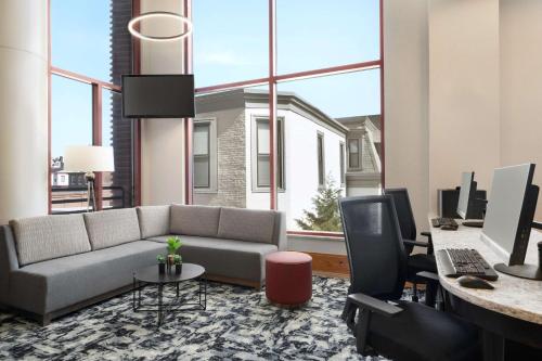 a living room with a couch and a desk with a computer at Homewood Suites University City Philadelphia in Philadelphia