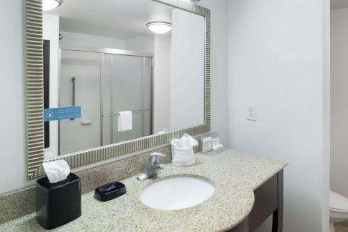 a bathroom with a sink and a mirror at Hampton Inn & Suites Panama City Beach-Pier Park Area in Panama City Beach