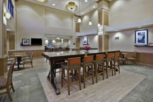 a large dining room with a large table and chairs at Hampton Inn & Suites Plattsburgh in Plattsburgh