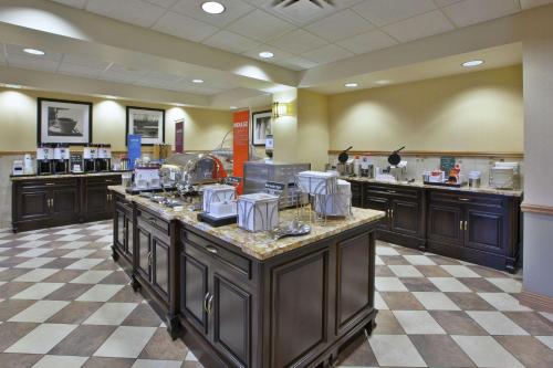 a large kitchen with a large island in a restaurant at Hampton Inn & Suites Plattsburgh in Plattsburgh