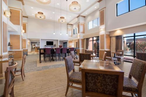 a large lobby with a dining room and living room at Hampton Inn & Suites Plattsburgh in Plattsburgh