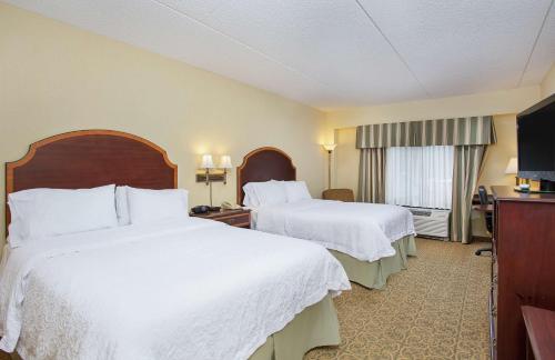 a hotel room with two beds and a television at Hampton Inn Pikeville in Pikeville