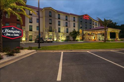 a hotel with a parking lot in front of it at Hampton Inn & Suites Pensacola/I-10 Pine Forest Road in Pensacola