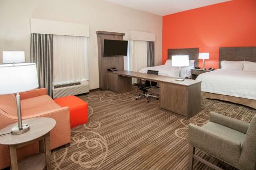 a hotel room with two beds and a desk at Hampton Inn & Suites Pensacola/I-10 Pine Forest Road in Pensacola