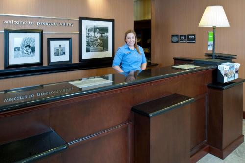 a woman standing behind a counter in a hotel room at Hampton Inn & Suites Prescott Valley in Prescott Valley