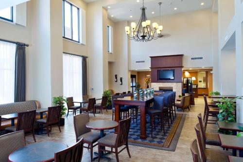 a restaurant with tables and chairs and a fireplace at Hampton Inn & Suites Prescott Valley in Prescott Valley