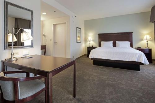 Habitación de hotel con cama, escritorio y mesa. en Hampton Inn & Suites Prescott Valley, en Prescott Valley