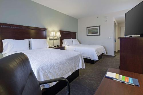 a hotel room with two beds and a flat screen tv at Hampton Inn & Suites Prescott Valley in Prescott Valley
