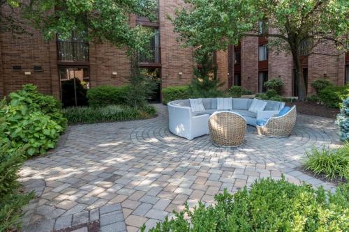 a patio with a couch and chairs in front of a building at Hampton Inn Parsippany in Parsippany