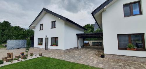 a white house with a courtyard at Penzion Panorama in Liptovský Mikuláš