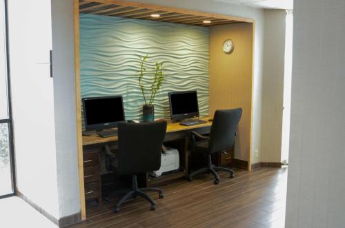 an office with a desk with two monitors and two chairs at Hampton Inn Perry in Perry