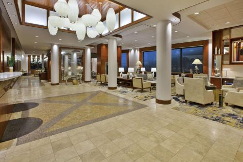 a lobby of a hotel with tables and chairs at Hilton Garden Inn Portland Downtown Waterfront in Portland