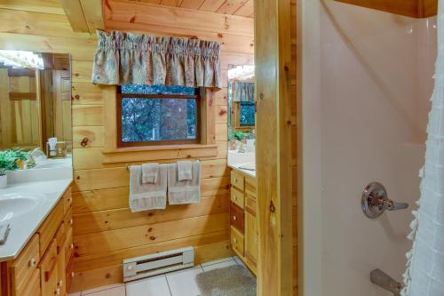 a bathroom with a sink and a mirror at Secluded Rustic Cabin Next to South Toe River! in Busick