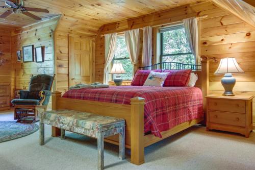 a bedroom with a bed in a log cabin at Secluded Rustic Cabin Next to South Toe River! in Busick