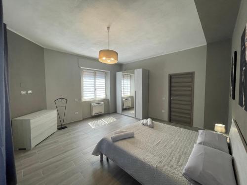 a bedroom with a large bed and a window at APPARTAMENTO ELEGANTE CARBONIA in Carbonia