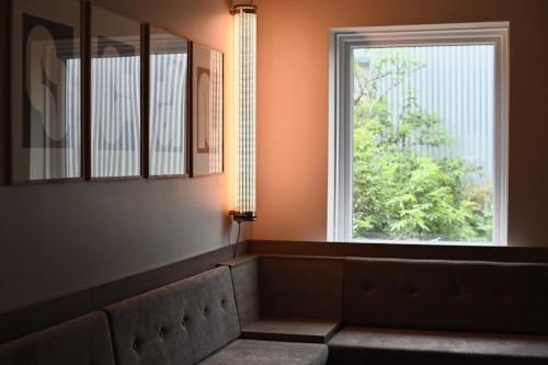 a room with a window and a couch and a light at Hotel Local 101 in Reykjavík
