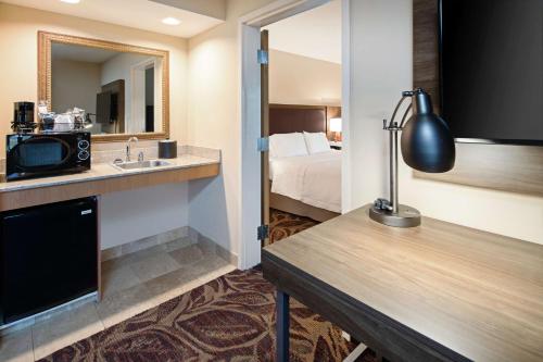 a hotel room with a sink and a bed at Hampton Inn & Suites Bremerton in Bremerton