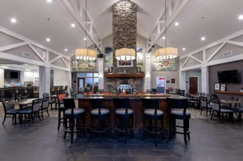 a bar in a restaurant with chairs and tables at Hampton Inn & Suites Raleigh Cary Lenovo Center in Cary