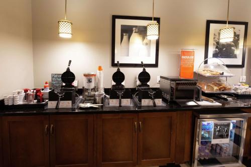 a counter in a room with a counter top with some food at Hampton Inn & Suites Raleigh Cary Lenovo Center in Cary