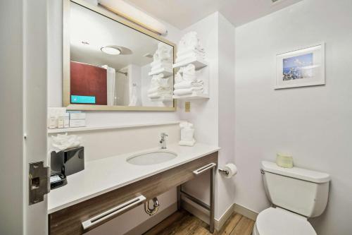 a white bathroom with a sink and a toilet at Hampton Inn Wilson Downtown in Wilson