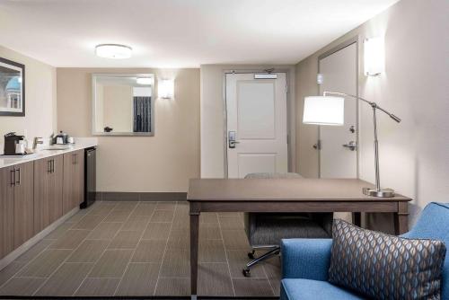 an office with a desk and a chair and a table at Hampton Inn & Suites Chapel Hill/Durham in Chapel Hill