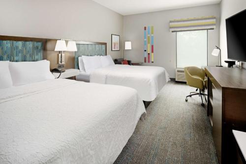 a hotel room with two beds and a desk at Hampton Inn Richmond-Mechanicsville in Mechanicsville
