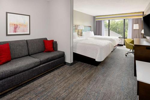 a hotel room with a bed and a couch at Hampton Inn Richmond-Mechanicsville in Mechanicsville