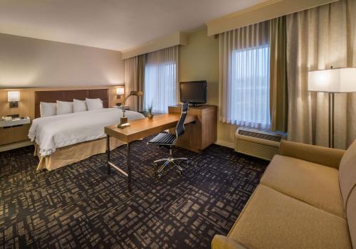 a hotel room with a bed and a desk at Hampton Inn & Suites Reno in Reno