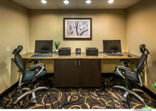an office with two computers on a desk with chairs at Hampton Inn & Suites Reno in Reno