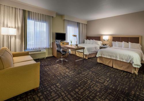 a hotel room with two beds and a desk at Hampton Inn & Suites Reno in Reno