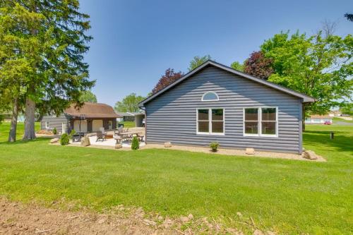 a blue house with a yard in front of it at Spacious Massillon Log Cabin with Fire Pit! in Massillon