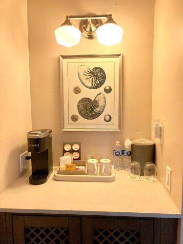 a counter in a hotel room with a tray of food at Sand Pebbles Inn in Cambria