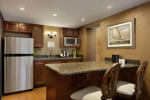 a kitchen with a refrigerator and a counter top at Hilton Garden Inn Rochester/Pittsford in Bushnell Basin