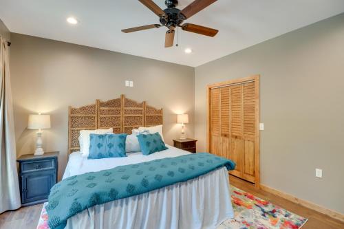 a bedroom with a bed and a ceiling fan at Gorgeous Drasco Home Near Greers Ferry Lake! in Heber Springs