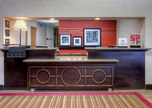a lobby of a hotel with a reception desk at Hampton Inn Russellville in Russellville