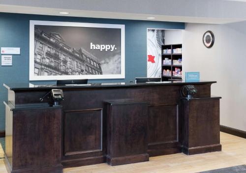 a pharmacy counter with a happy sign on the wall at Hampton Inn & Suites Rochester-North in Rochester