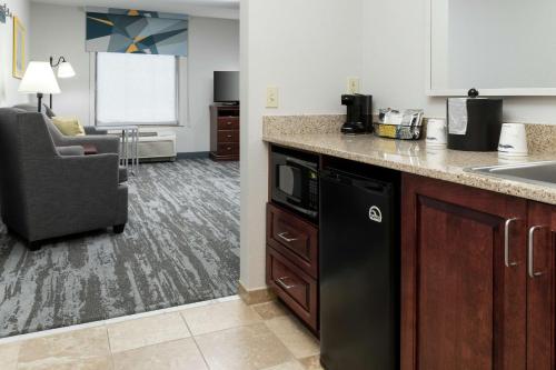 a kitchen with a black dishwasher and a sink at Hampton Inn & Suites Rochester-North in Rochester