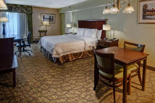 a hotel room with a bed and a desk at Hampton Inn Rocky Mount in Rocky Mount